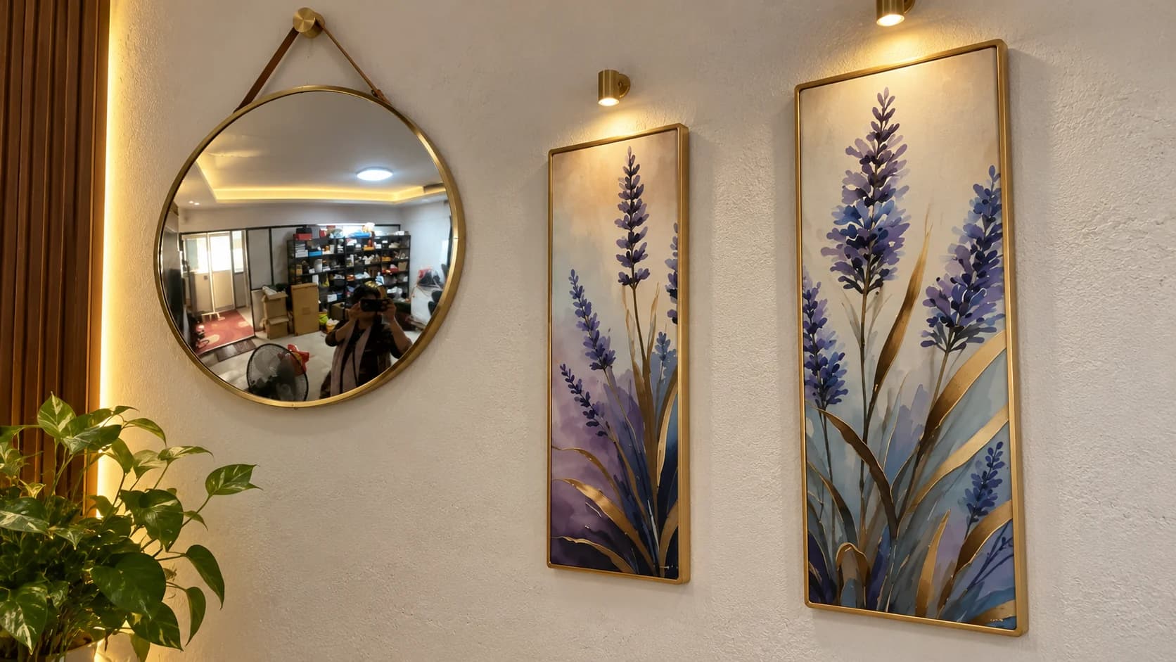 Inside the Lavender Breeze studio: lavender paintings in brass frames on a warmly lit wall
